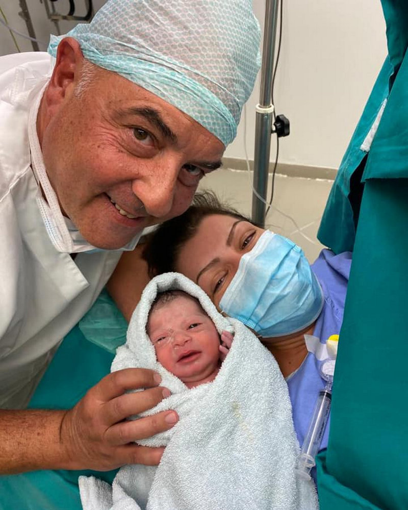 dr paraschos with newborn baby and mother