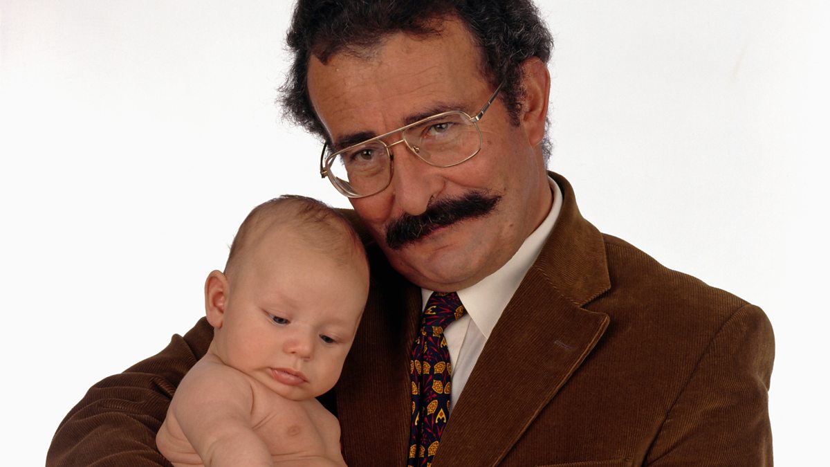 Lord Robert Winston holding a baby