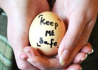 Women Holding An Egg